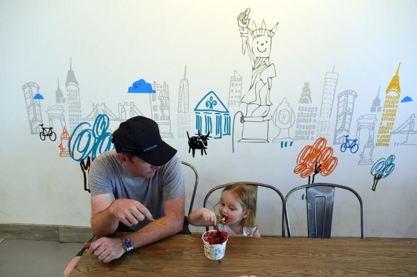 Shane Sullivan and his daughter Chloe, 2, enjoy the Supreme Berry at I-Ce_NY in Carrollton...