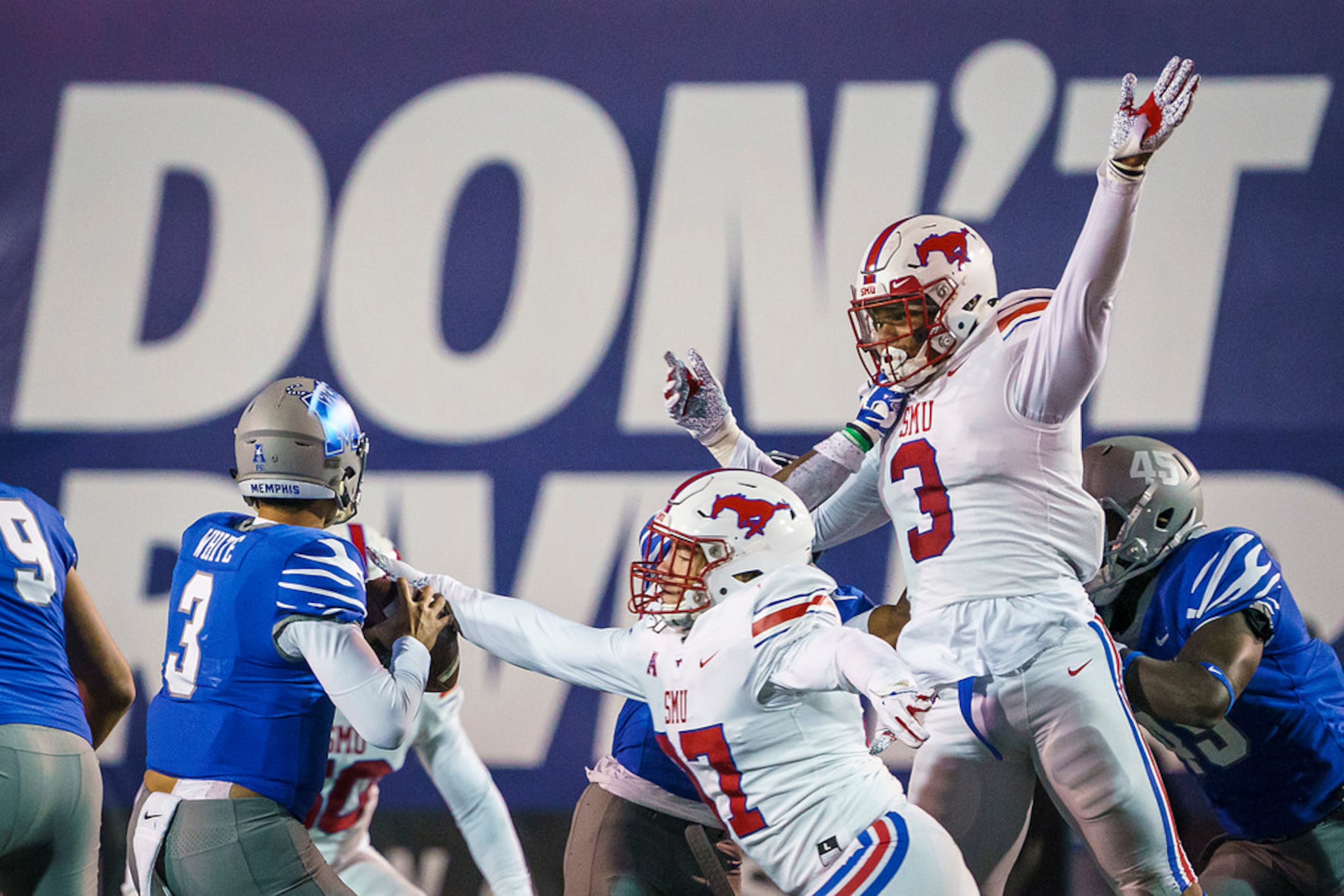 SMU defensive end Turner Coxe (97) and linebacker Delano Robinson (3) apply pressure to...