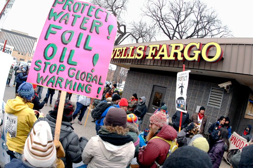 Dakota Access Pipeline protesters form a circle to sing, pray and demonstrate at a Wells...