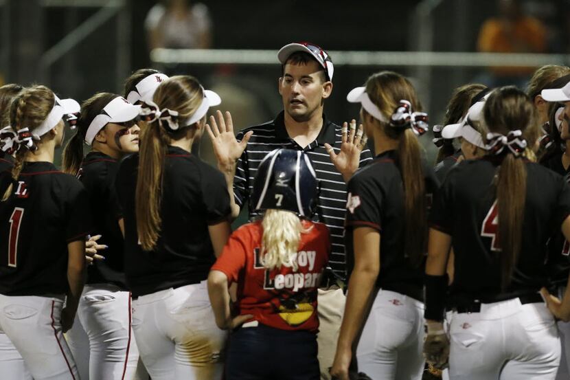 Lovejoy coach Jeff Roberts gives his player instructions between innings during a high...