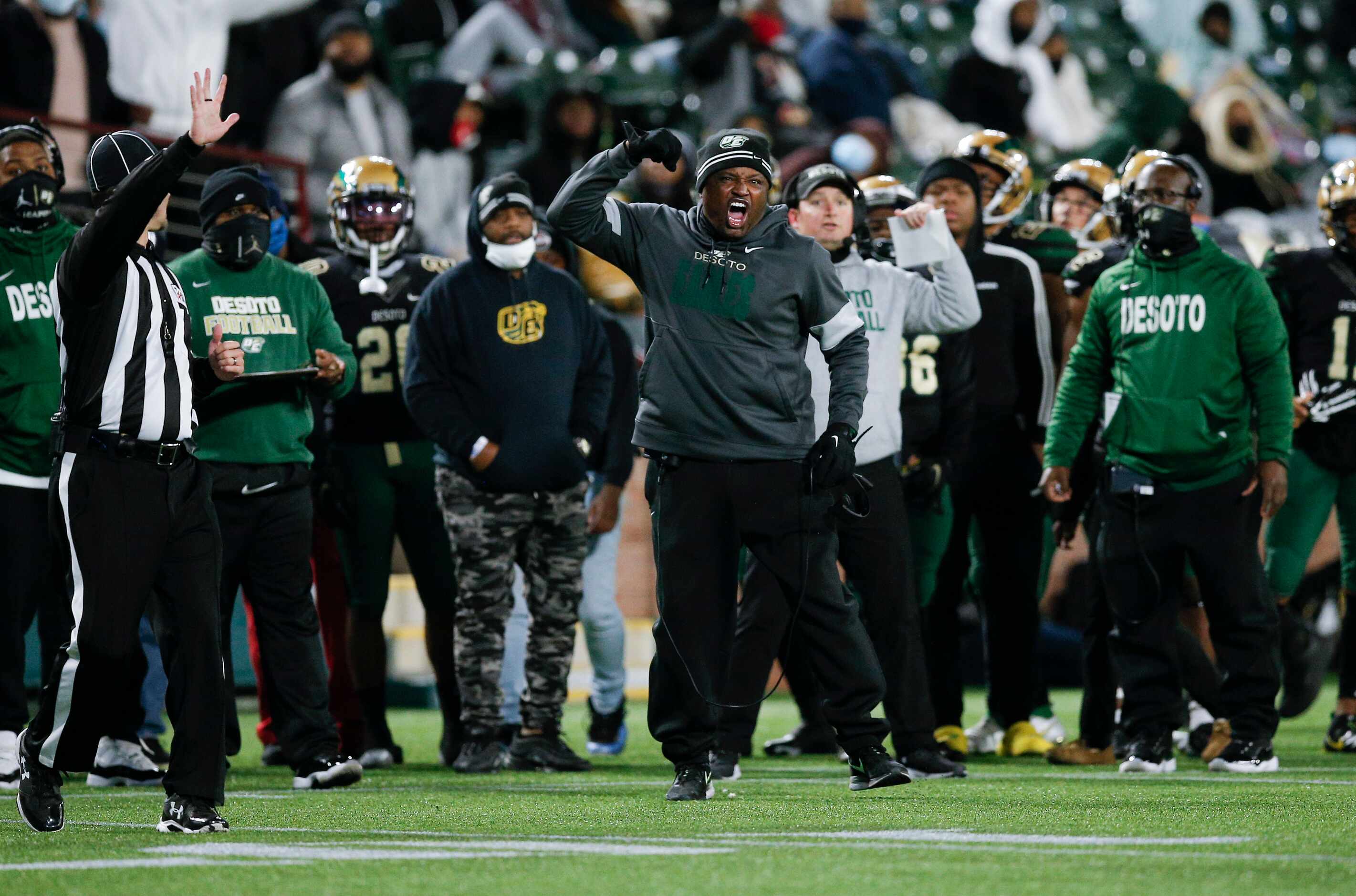 DeSoto head coach Claude Mathis, center, argues for a call during the first half of a Class...