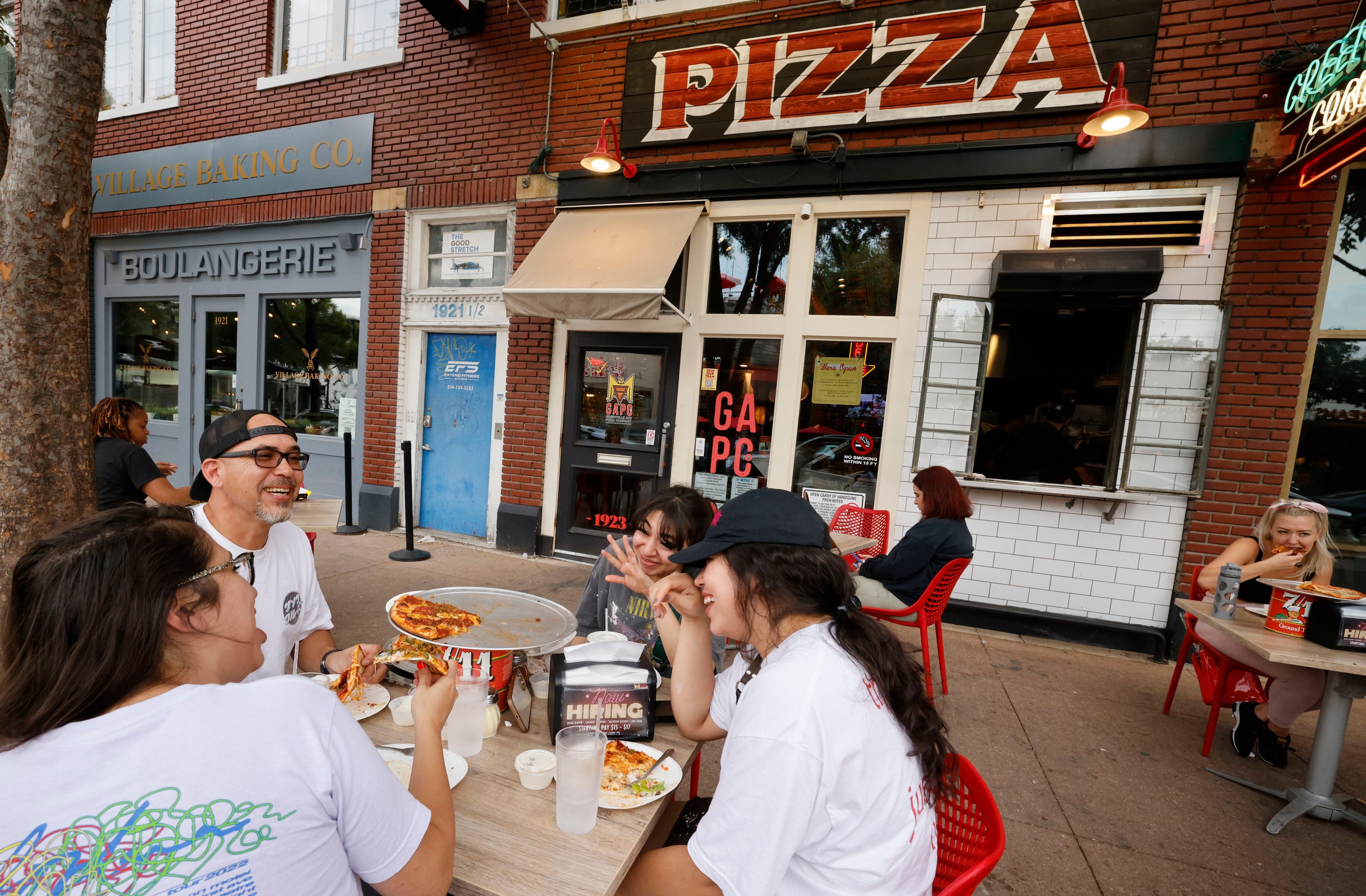 Cris Alvarez of Dallas has pizza with his sisters Amber Alvarez, clockwise from Cris,...