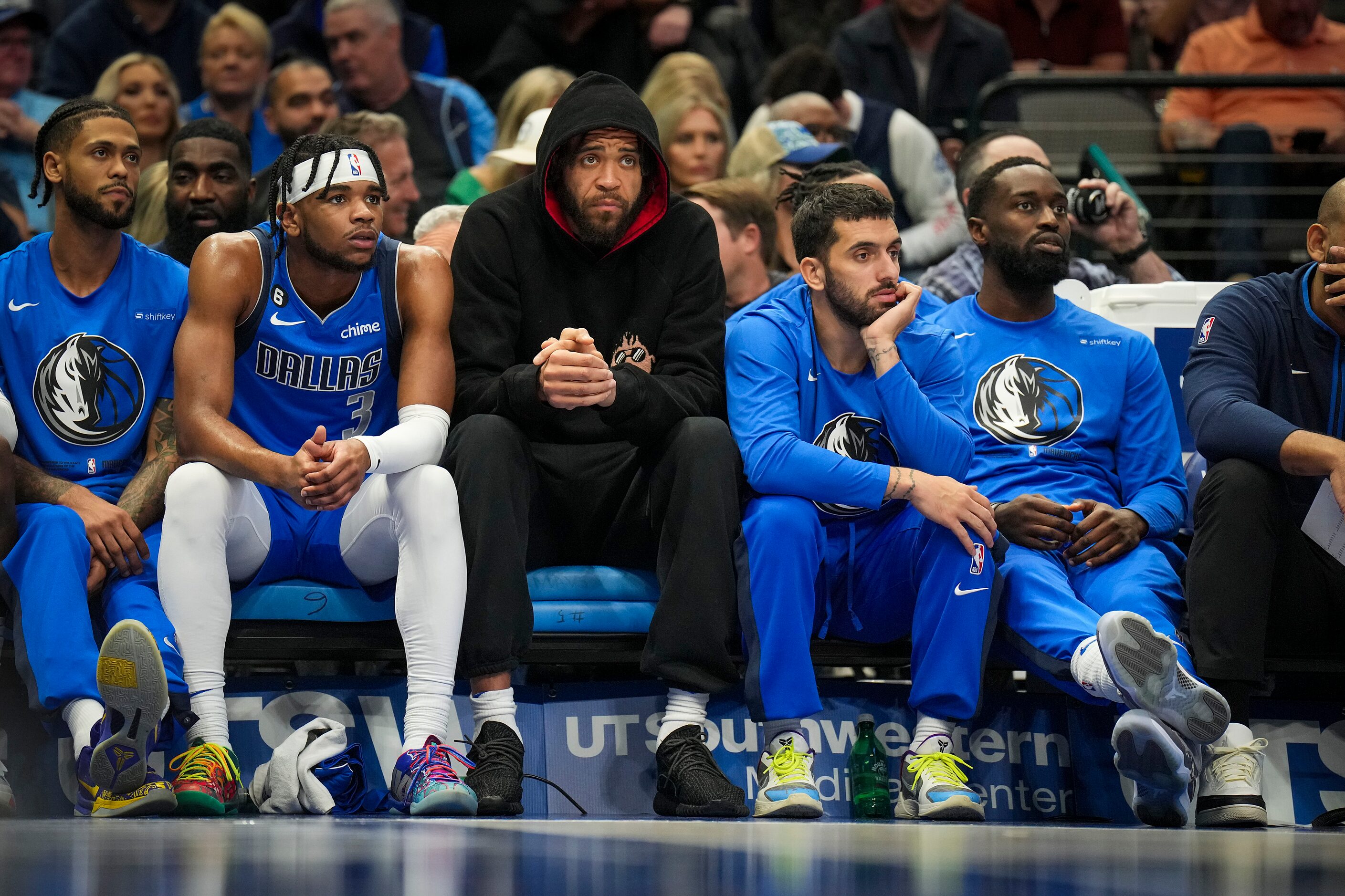 Dallas Mavericks center JaVale McGee (wearing hoodie) watches from the bench during the...