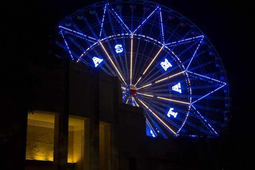 The Texas Star Ferris wheel seen lit up at night during the free festival celebrating the...