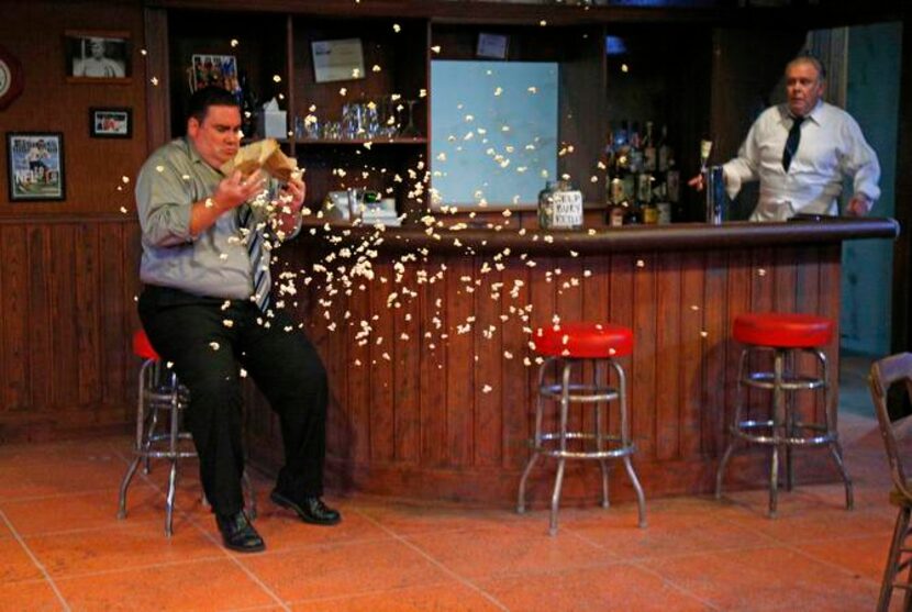 Eric Wilder (Donnie, left) pops open a popcorn bag as John S. Davies (Lou) tends bar in a...