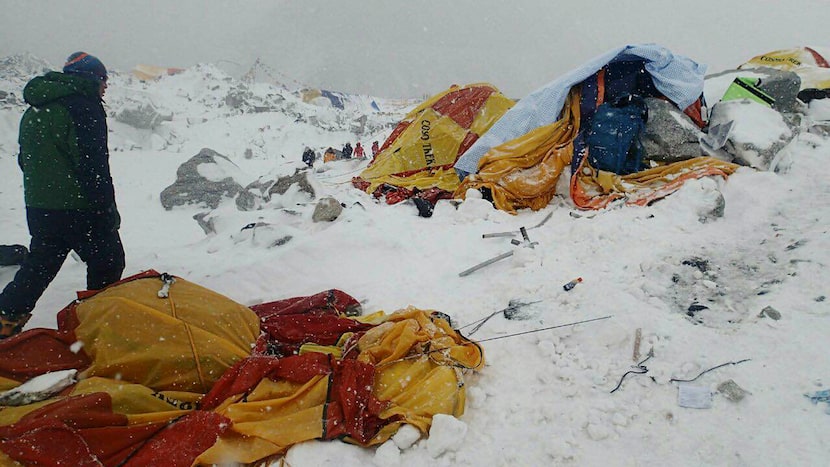 In this photo provided by Azim Afif a man approaches the scene after an avalanche triggered...