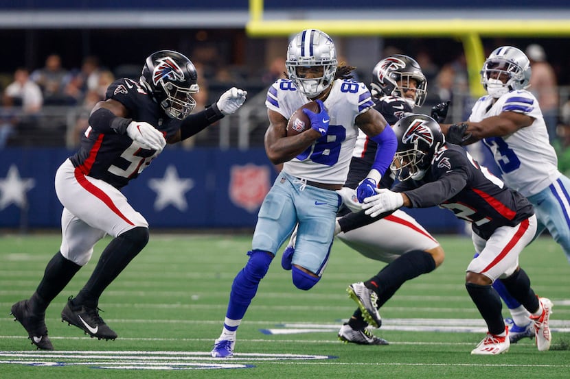 Dallas Cowboys wide receiver CeeDee Lamb (88) runs through the arms of Atlanta Falcons...