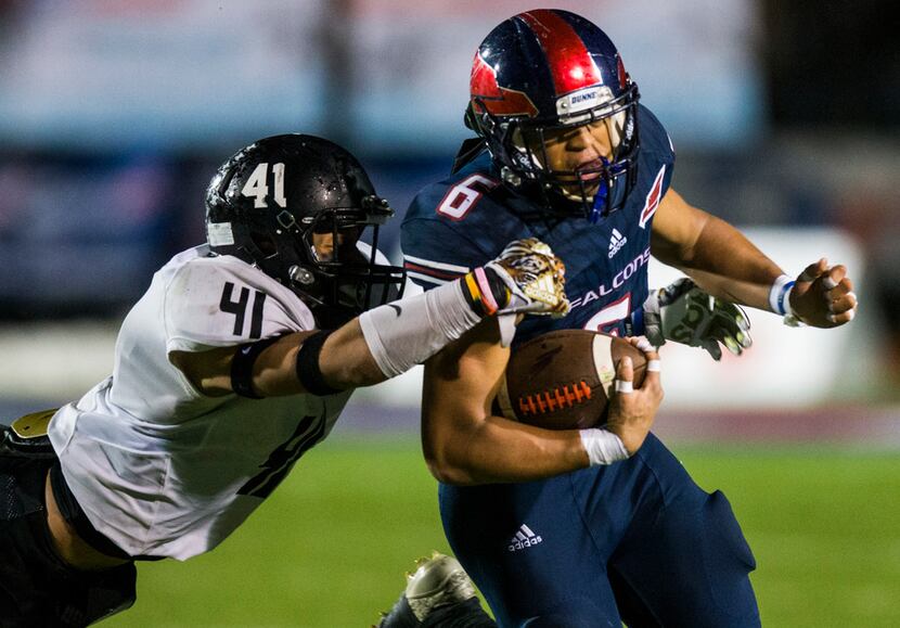 Bishop Dunne offensive back Jaden Hullaby (6) is brought down by Bishop Lynch defensive...