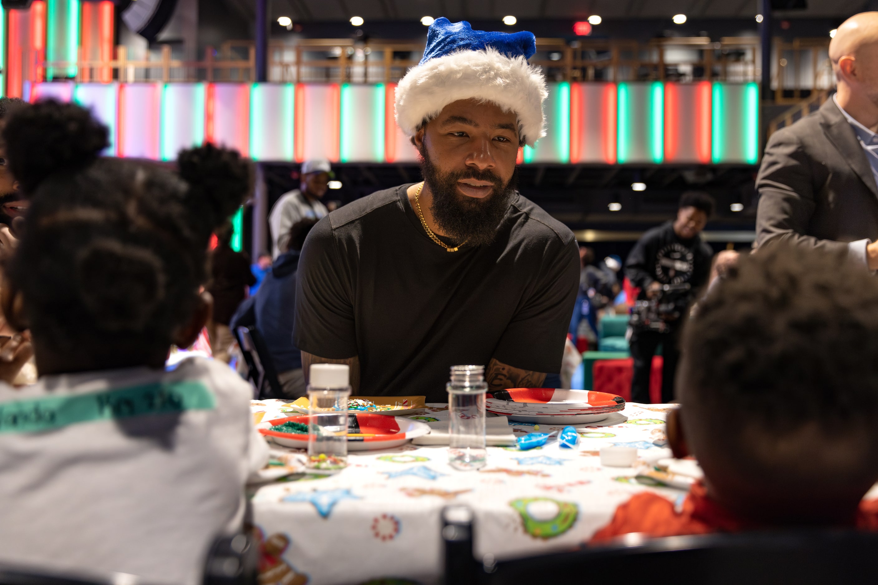 Mavericks forward-center Markieff Morris decorates cookies with kids during the Cookies With...