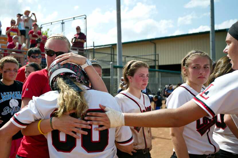 Lovejoy catcher Amanda Gray is consoled by teammates after the loss to Buda Hays in the...
