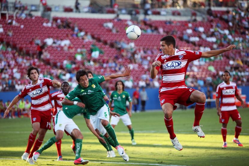 Leon forward Juan Carlos Pineda (5) prepares for a header against FC Dallas defender Matt...