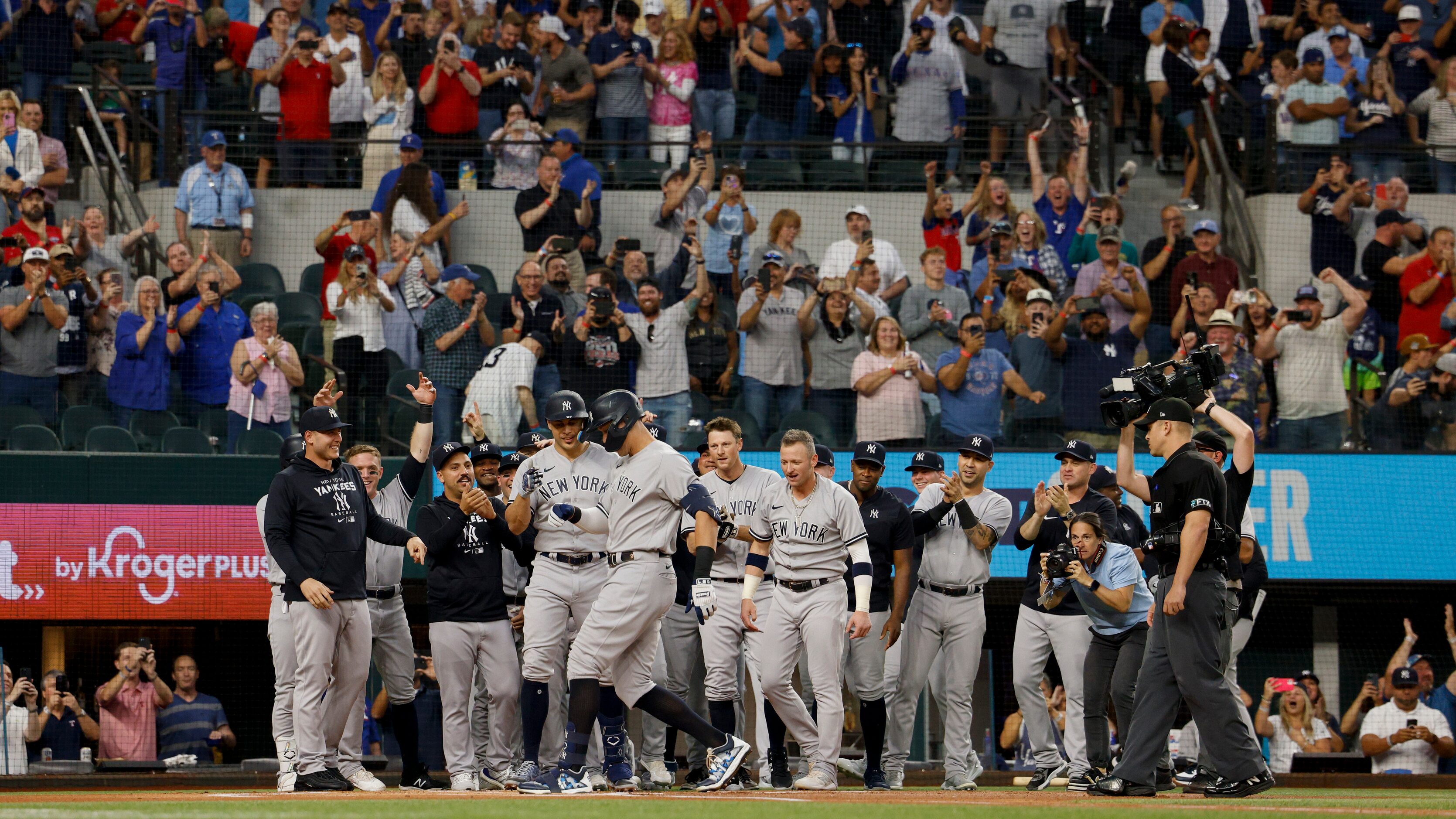 New York Yankees teammates greet right fielder Aaron Judge (99) as he touches home plate...