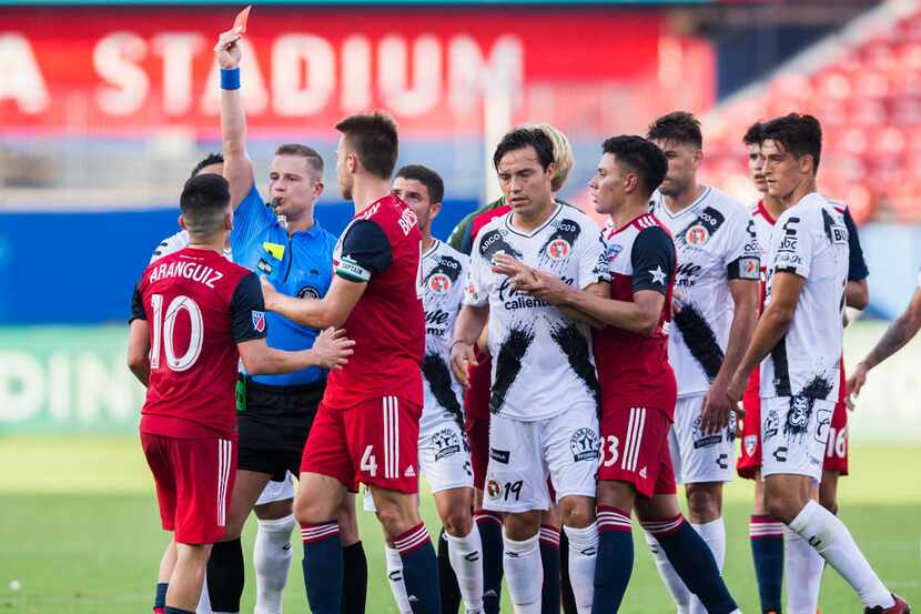 FC Dallas midfielder Pablo Aranguiz (10) gets a red card during the first half of a friendly...