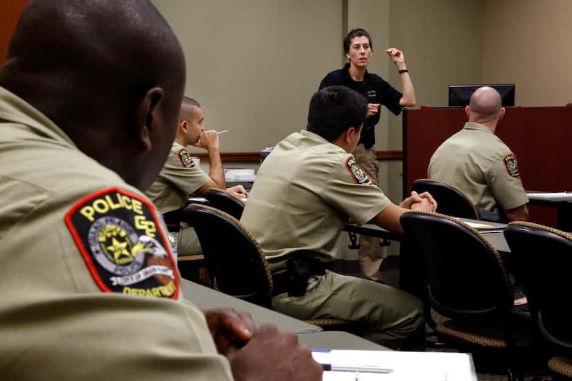 Grand Prairie Police officer J. Briggs, standing, teaches a class of 10 police recruits at...