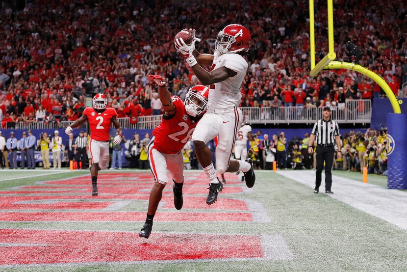 ATLANTA, GA - DECEMBER 01:  Jerry Jeudy #4 of the Alabama Crimson Tide catches a touchdown...