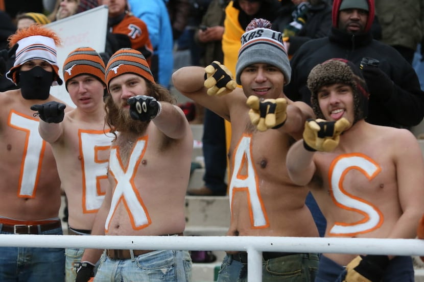 Longhorns fans brave the cold to cheer on their team during the University of Texas...