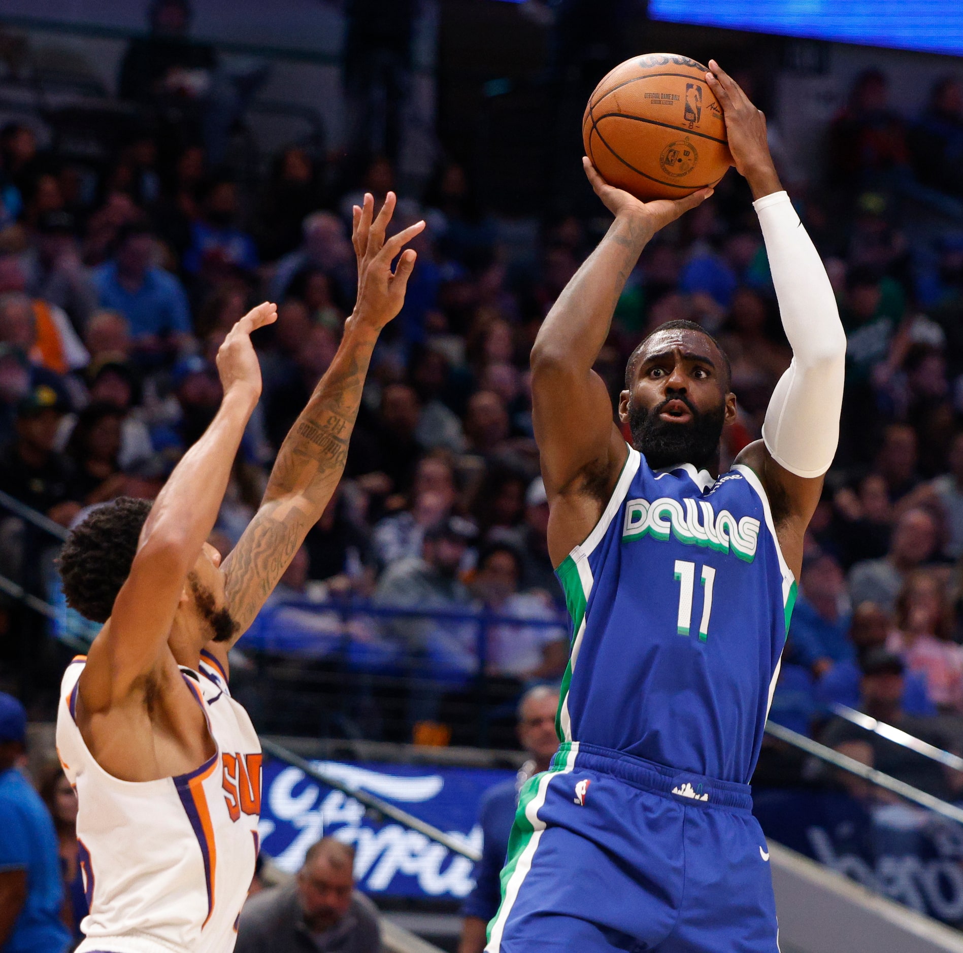 Dallas Mavericks forward Tim Hardaway Jr. (11) shoots the ball over Phoenix Suns guard...