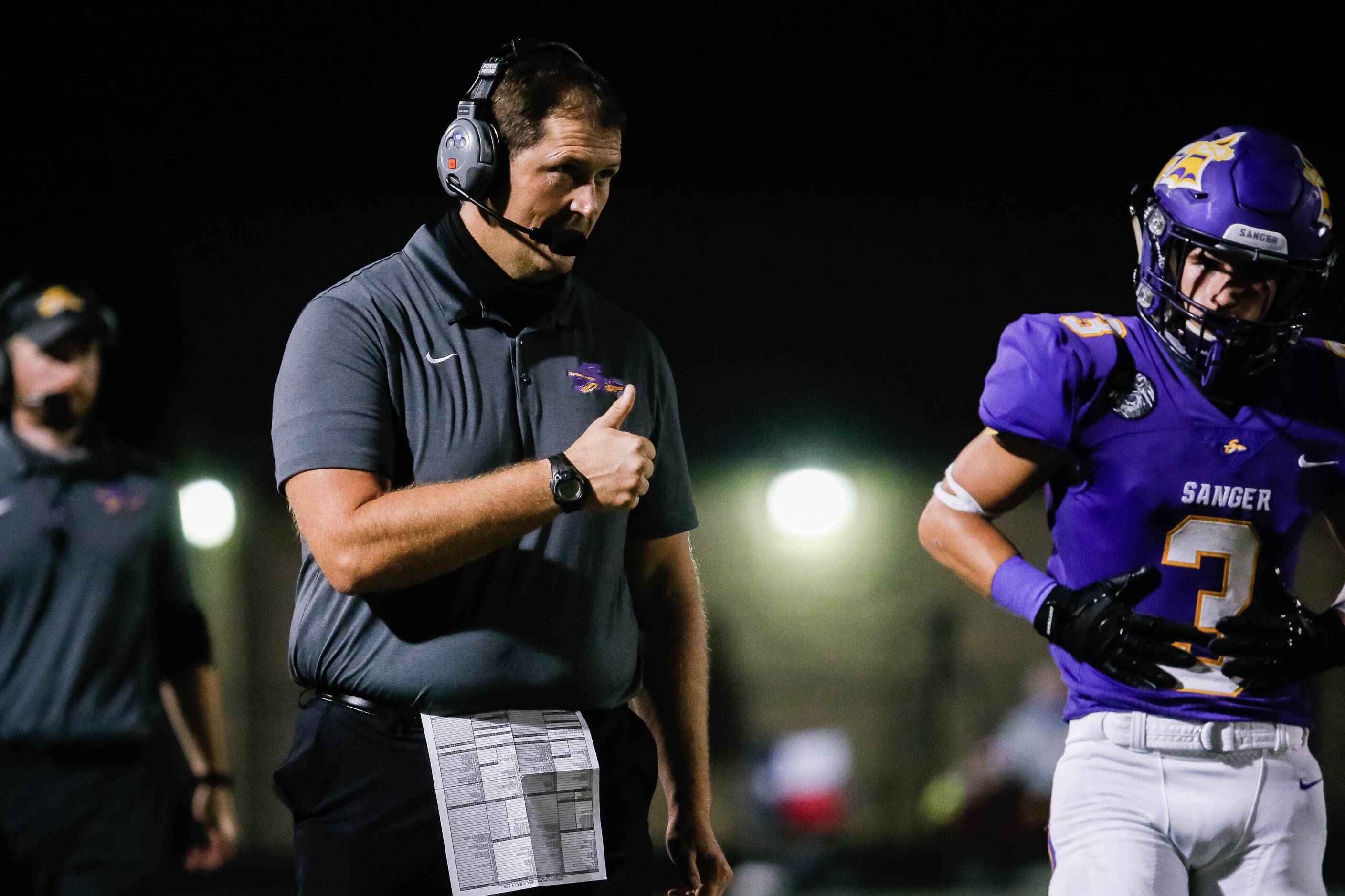 Sanger High School football head coach Rocky Smart gives a thumbs up during a game against...