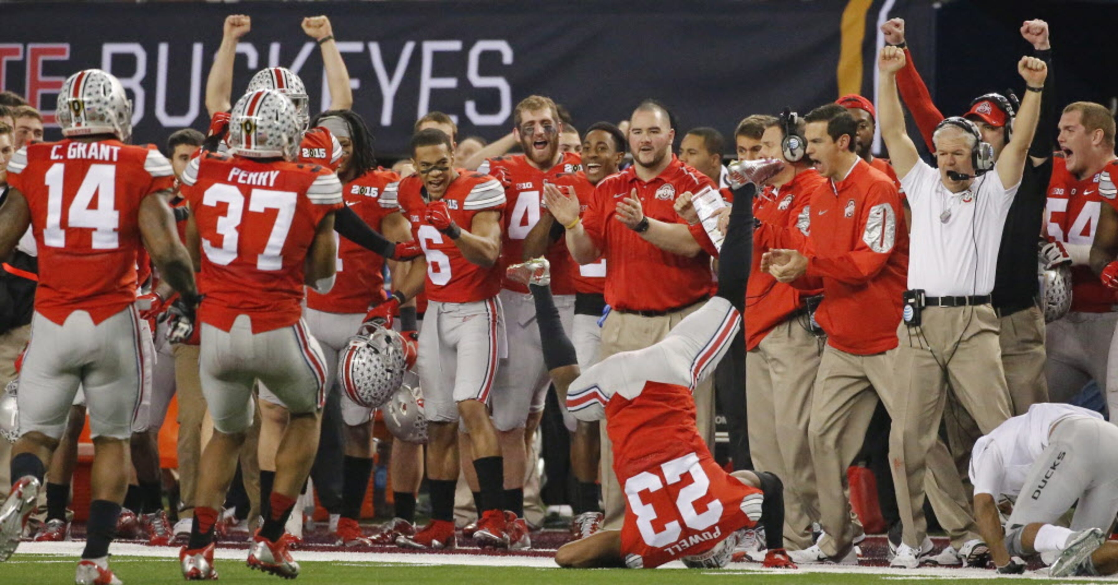 The Ohio State bench applauds a play by safety Tyvis Powell (23) in the fourth quarter...