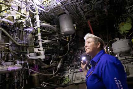 Jennifer Morgan, aircraft maintenance inspector, looked at the inside of a wheel base of a...