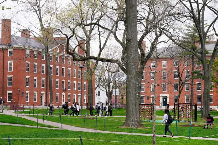 Students walk through Harvard Yard, April 27, 2022, on the campus of Harvard University in...