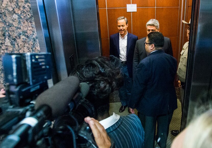 Speaker of the House Joe Straus (left) leaves the House Republican Caucus meeting Wednesday...