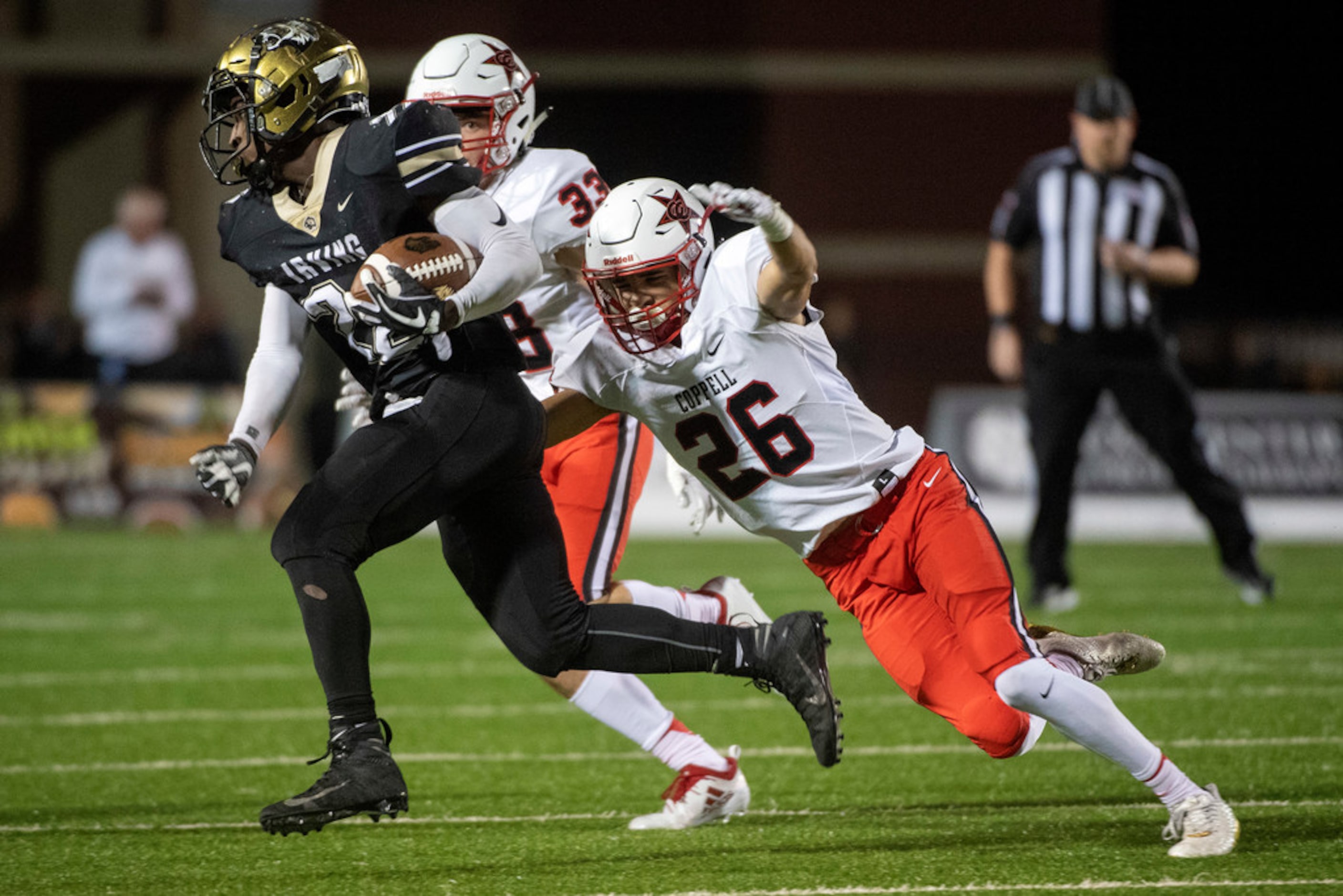 Coppell senior defensive back Noah Snelson (26) dives to tackle Irving senior running back...