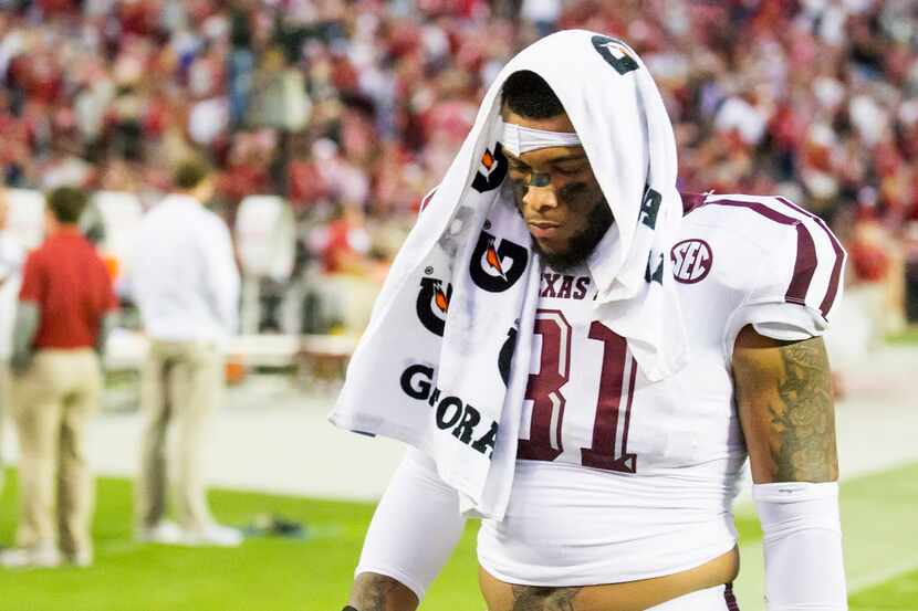 Texas A&M linebacker Claude George walks off the field after a loss to Alabama in an NCAA...