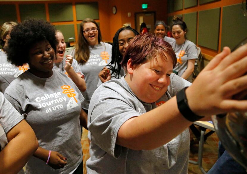 Marissa Anderson of Waco reacts  as static electricity builds as she touches a van de Graaff...