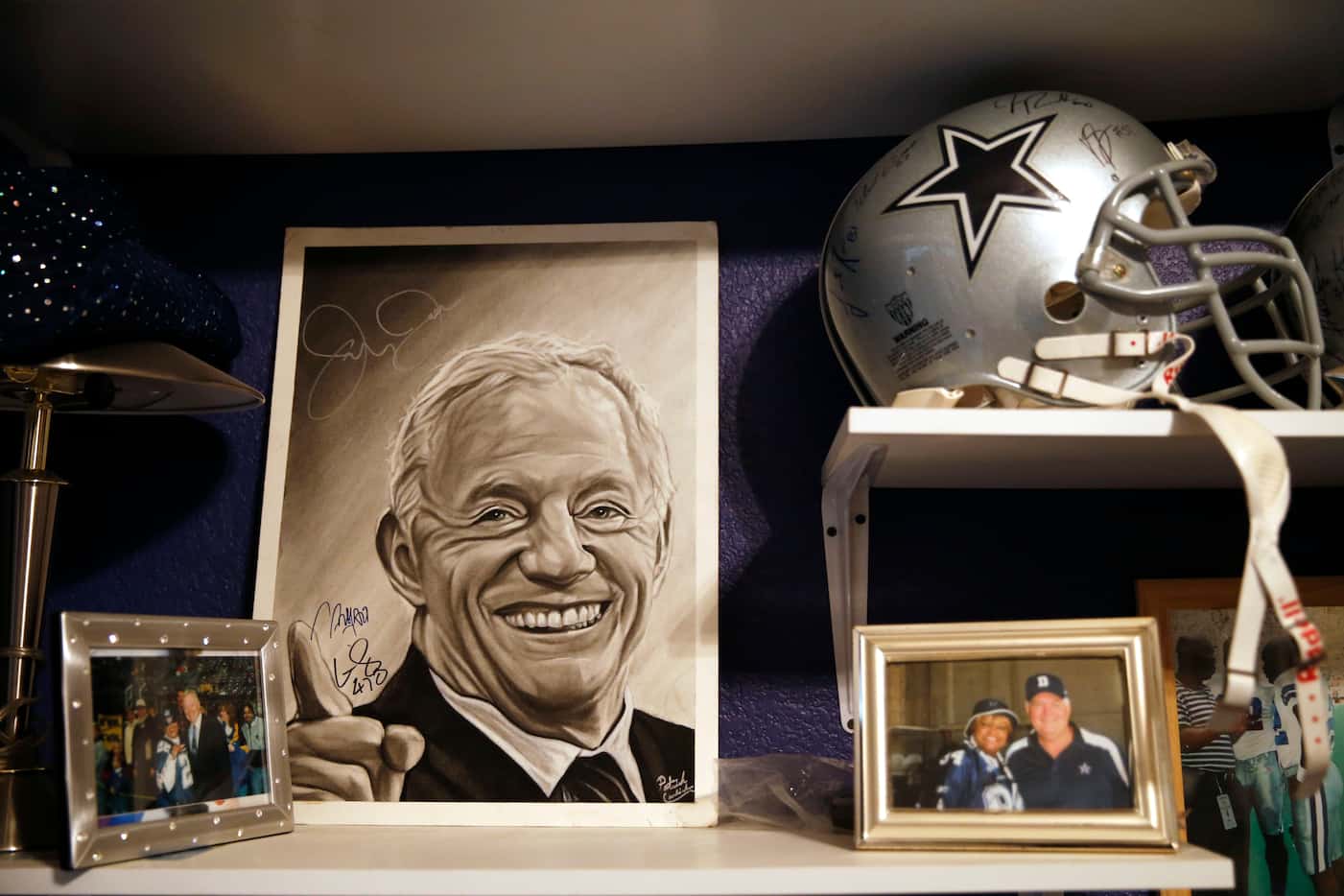 Jerry Jones artistic rendering and Dallas Cowboys memorabilia in a room at Dallas Cowboys...