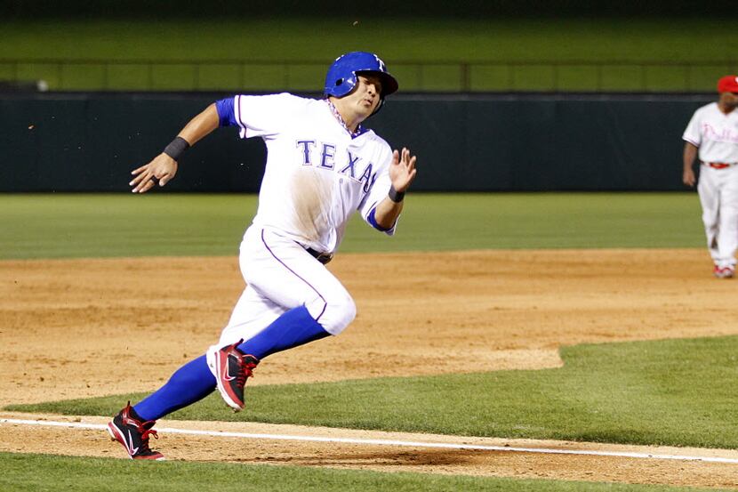 Texas Rangers left fielder Shin-Soo Choo (17) digs hard for home to score on Adrian Beltre's...