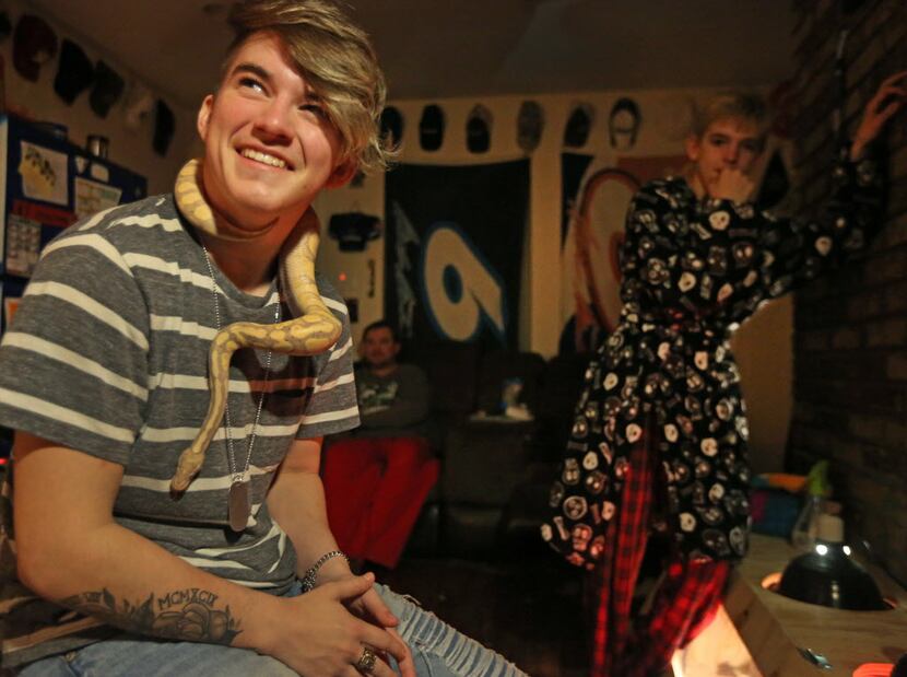 Wrestler Mack Beggs is pictured at home with pet snake "Caesar" as younger brother Harley...