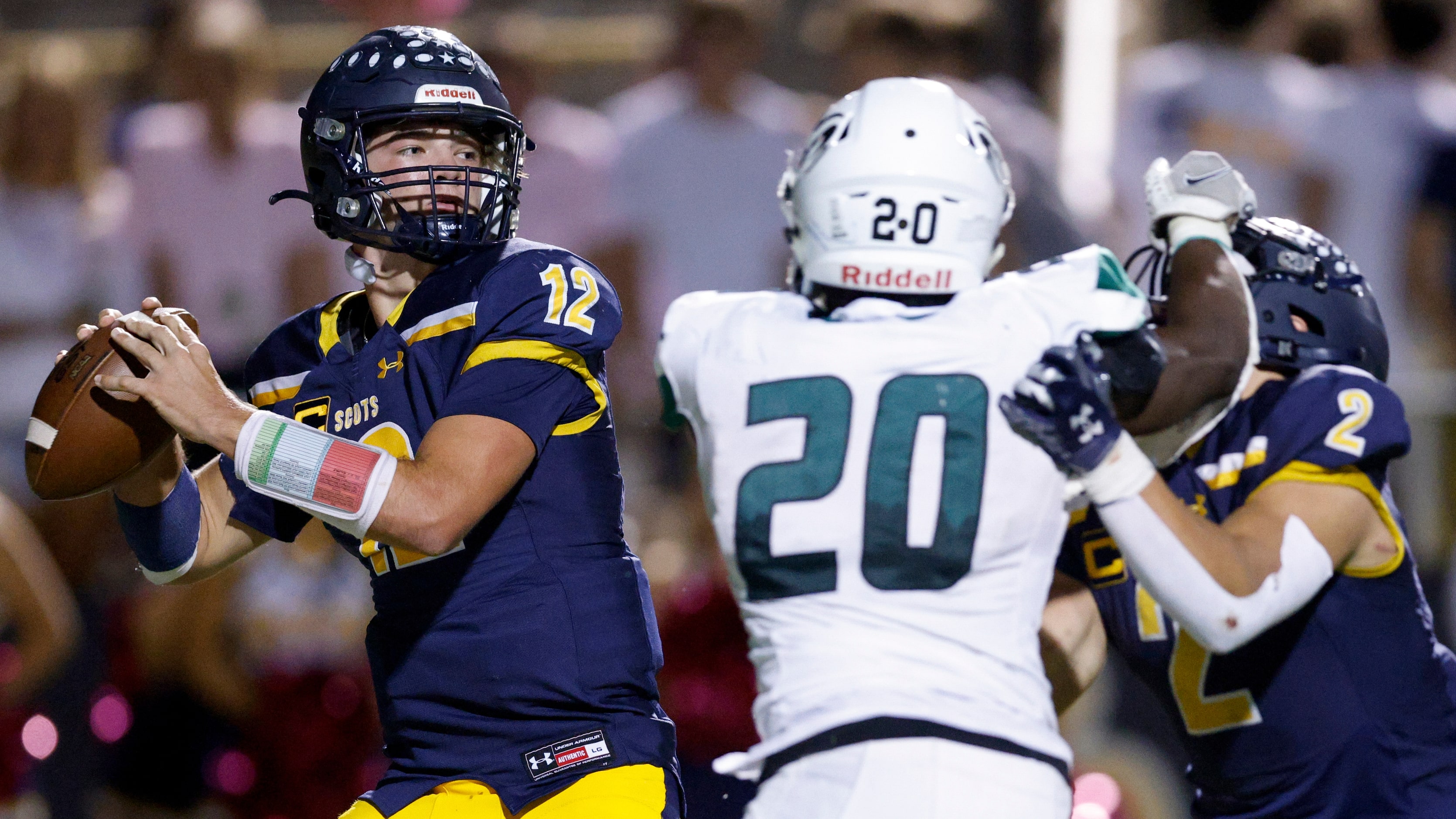 Highland Park quarterback Warren Peck (12) throws under pressure from Richardson Berkner...