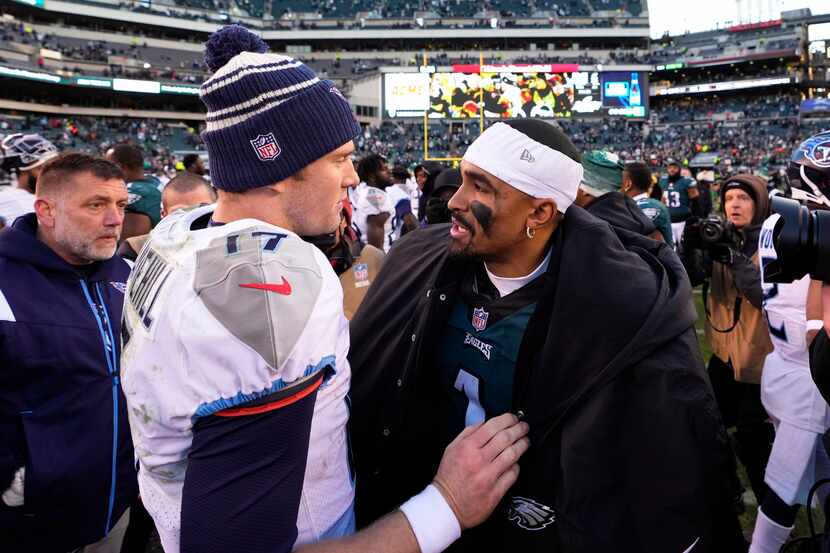 Tennessee Titans' Ryan Tannehill, left, talks with Philadelphia Eagles' Jalen Hurts after an...