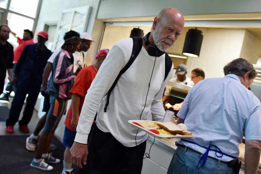 Charlie Hodges, 50, carries his lunch during the National Hunger Awareness Day at The Bridge...
