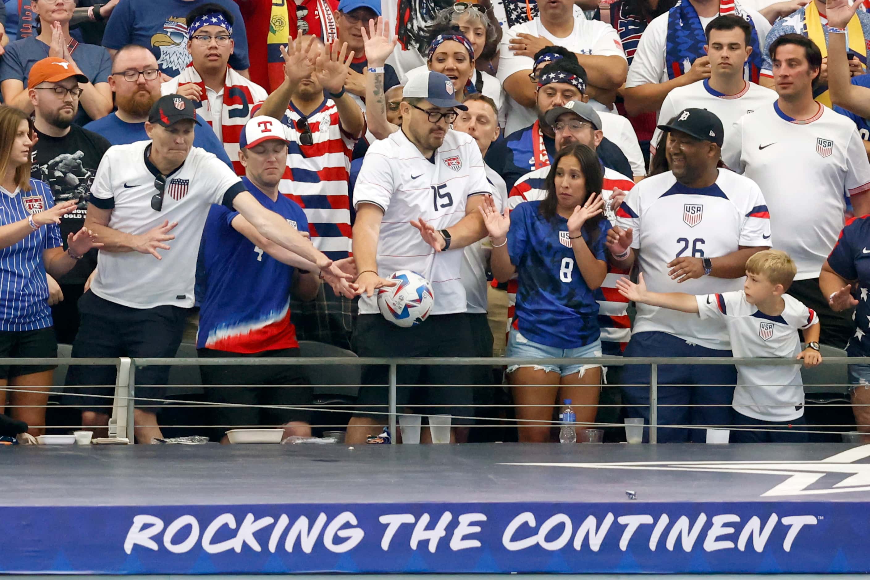 United States soccer fans react as the ball flies into the seats during the first half of a...