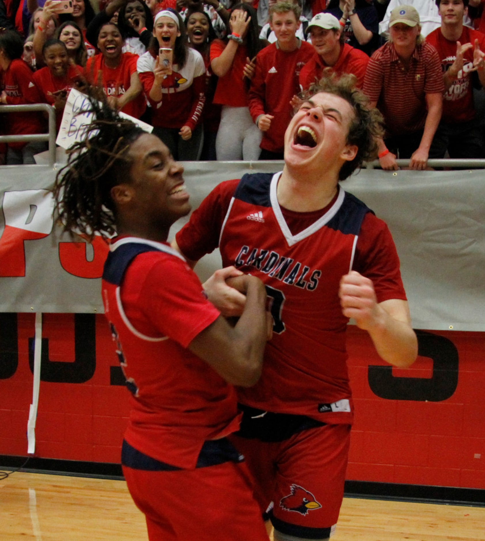 Plano John Paul ll teammates Nathan Dominick (10), right, and Jalen Tot (2) celebrate their...