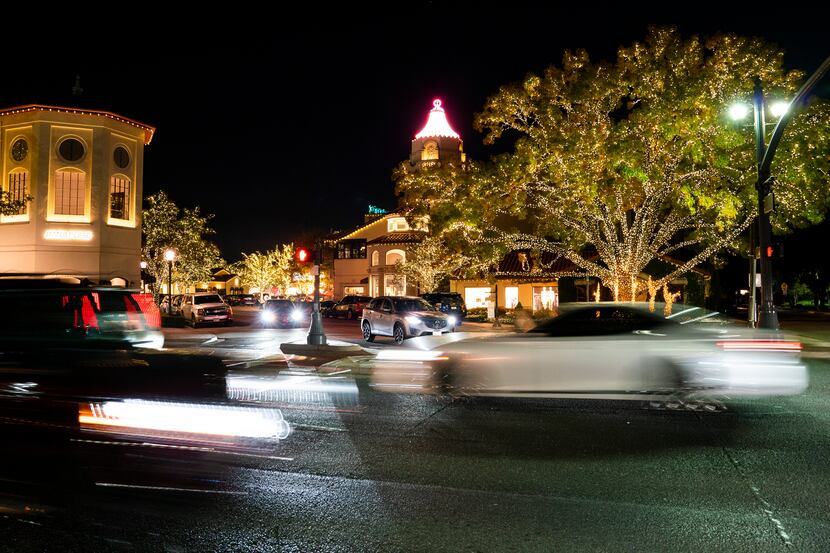 Christmas lights decorate the streets of the Highland Park Village shopping center. The...