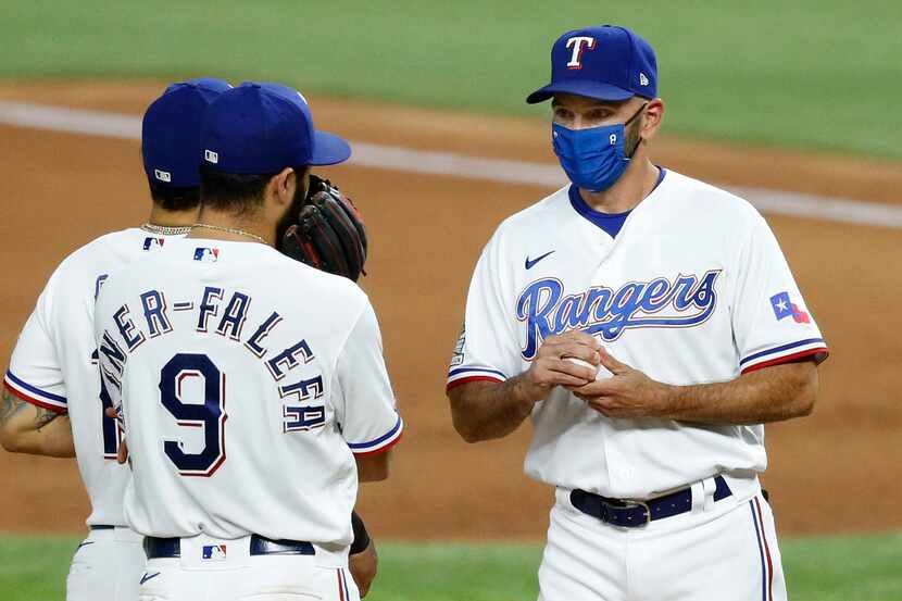 FILE — Texas Rangers manager Chris Woodward (right) visits with shortstop Isiah Kiner-Falefa...