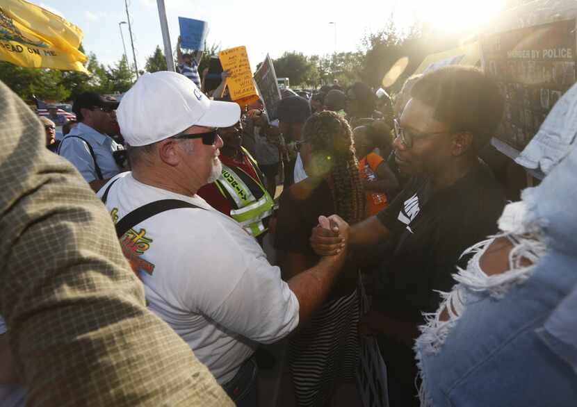 Scott Harmeling (left), who says he supports the McKinney police, finds a point of agreement...