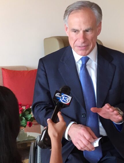 Gov. Greg Abbott debriefs TV pool reporter Pooja Lodhia of Houston's KTRK-TV about his...