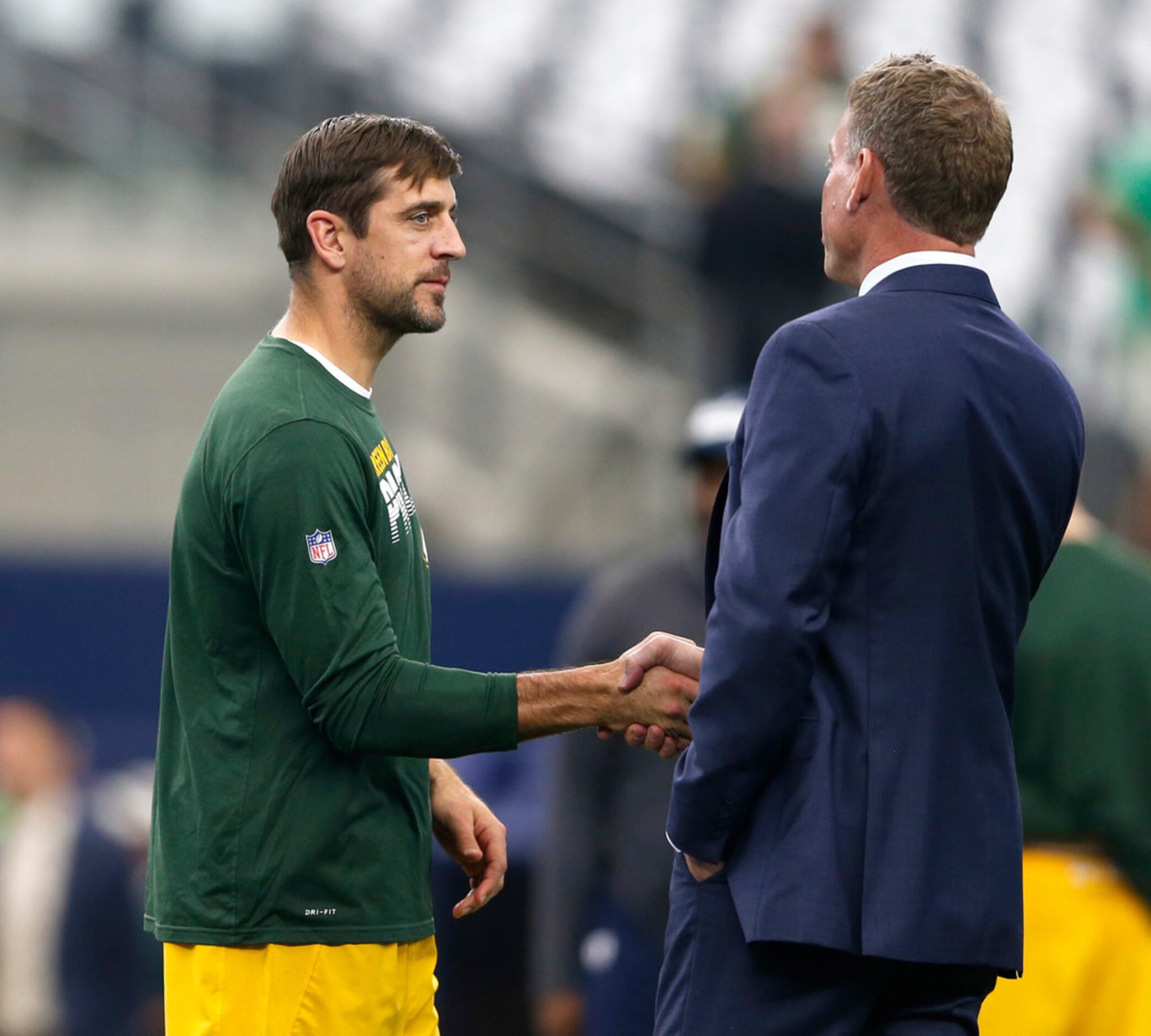 Green Bay Packers quarterback Aaron Rodgers (12) talks with former Dallas Cowboys...