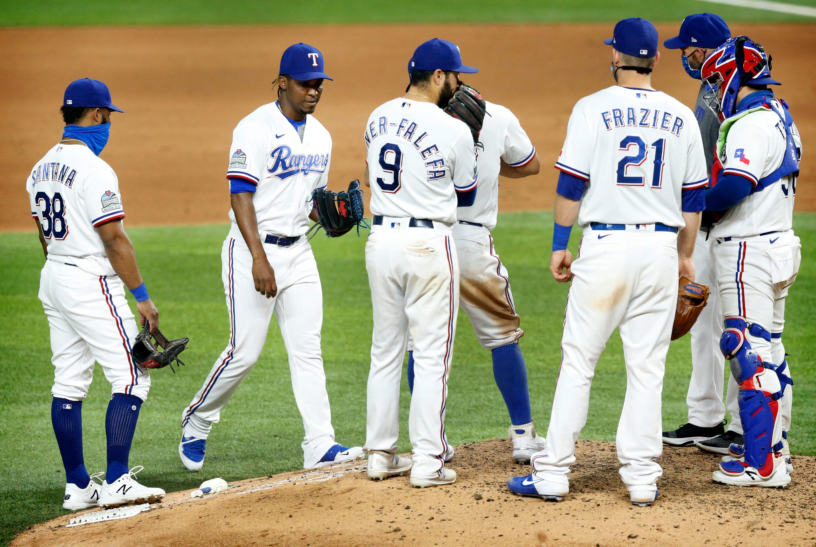 Texas Rangers relief pitcher Rafael Montero (second from left) arrives at the mound in the...