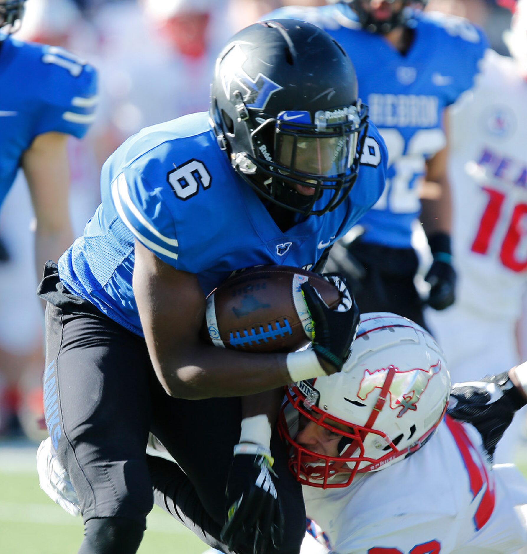 Hebron High School running back Jaylon Lott (6) is met by Pearce High School strong safety...