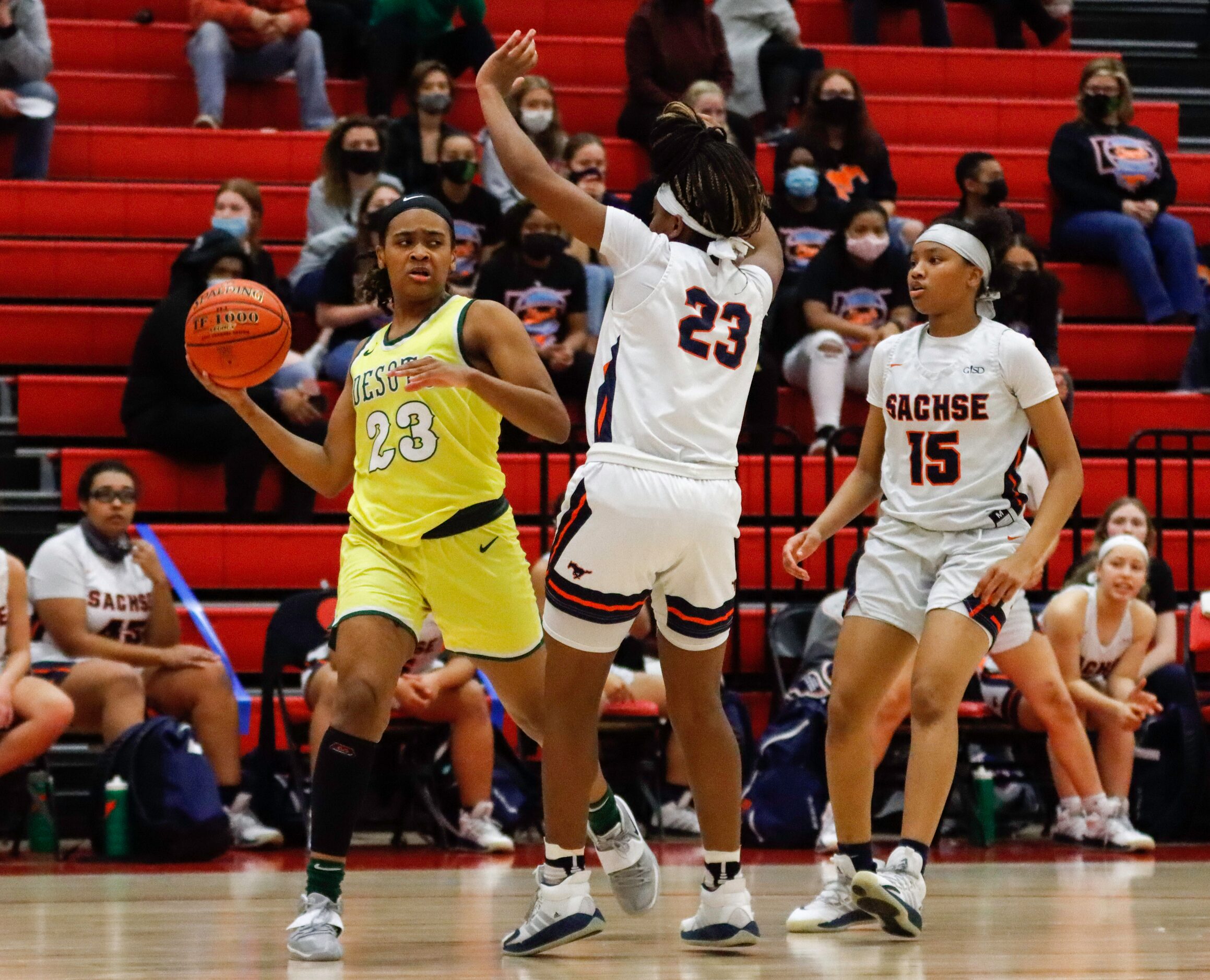 DeSoto’s Kendall Brown (23) looks to pass around Sachse’s Crislyn Rose (23) during the...