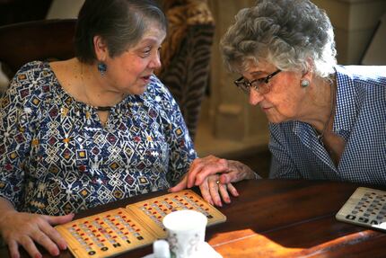 Bonnie Carlson, (left)  talks with her friend, Edith Crittenden during their weekly bingo...
