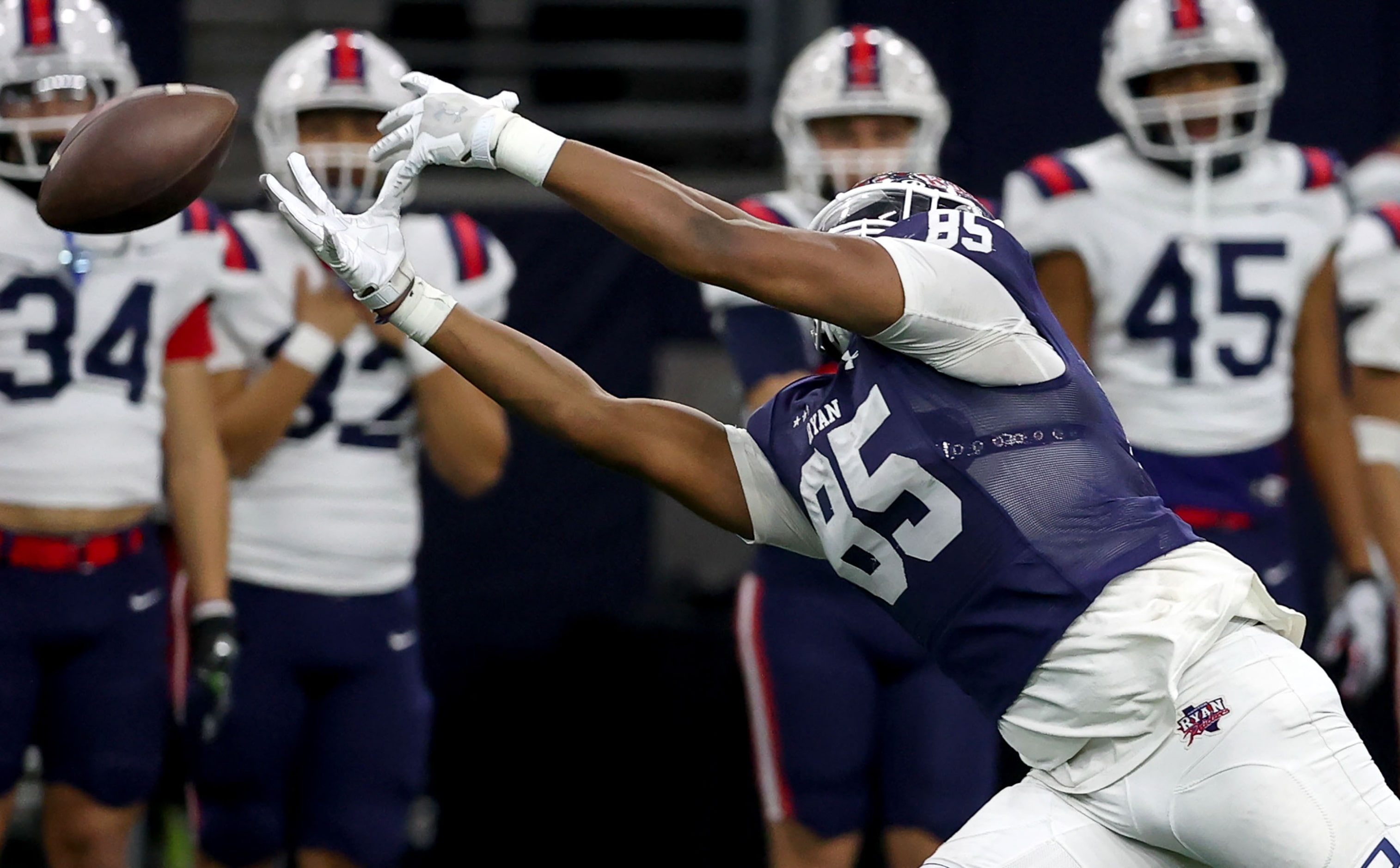 Denton Ryan half back Joses Melendez reaches out but can't come up with a reception against...