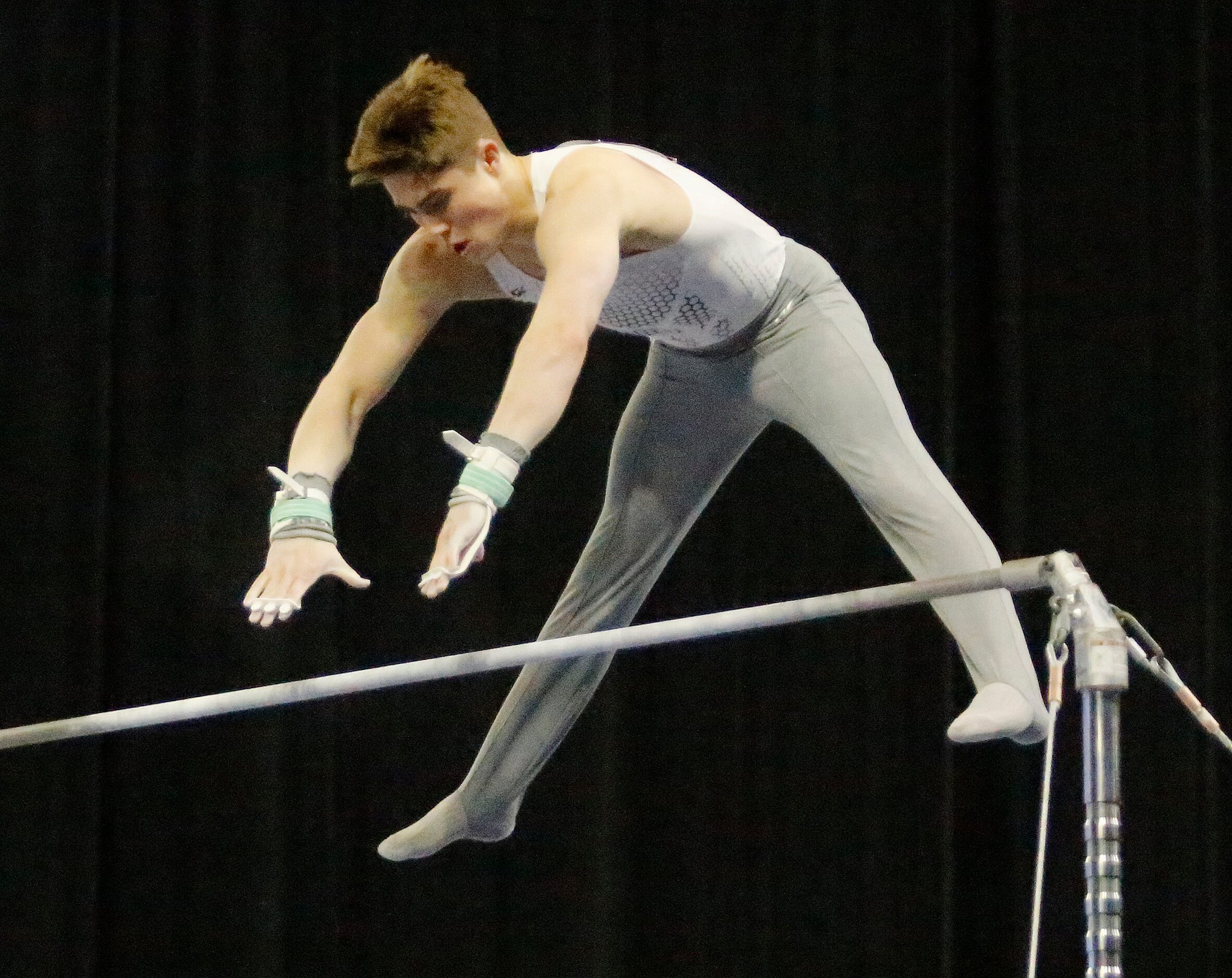 Cole Partridge with USA Gym World performs on the high bar in the mens finals during the USA...