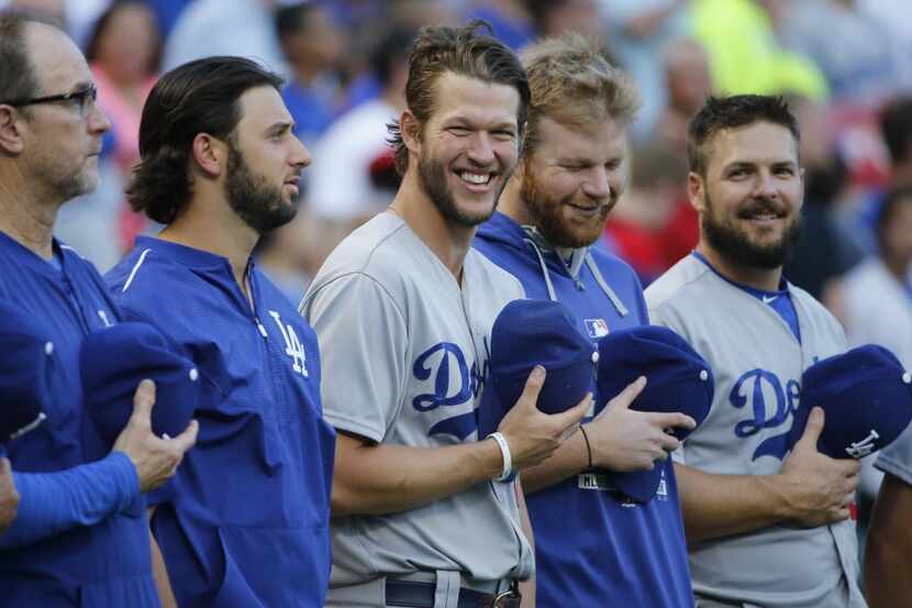 Los Angeles Dodgers pitcher Clayton Kershaw, center, enjoys a laugh with teammates during...
