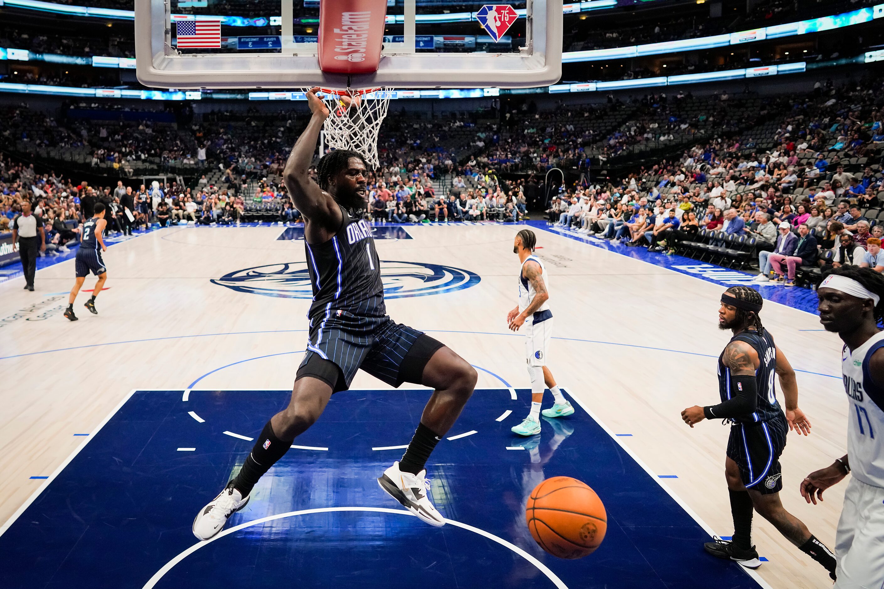 Orlando Magic forward Jonathan Isaac (1) dunks the ball past Dallas Mavericks forward...